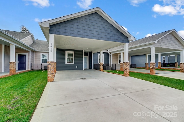 craftsman-style home featuring a front yard and a carport