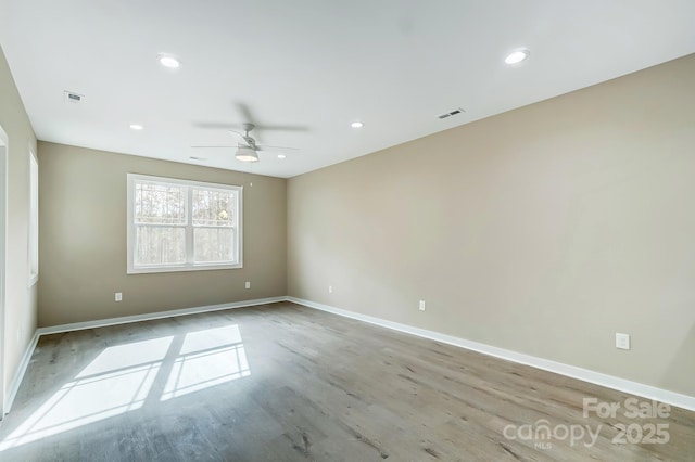 spare room featuring ceiling fan and light hardwood / wood-style floors