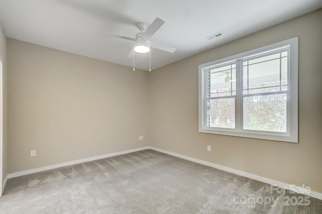 carpeted spare room featuring ceiling fan