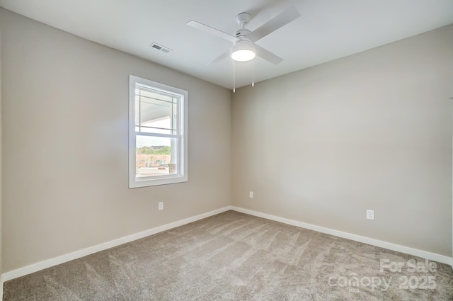 empty room featuring ceiling fan and light colored carpet