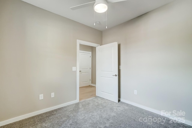 carpeted empty room with ceiling fan