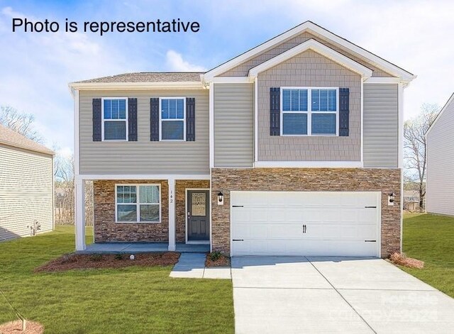 view of front of property featuring a garage and a front yard