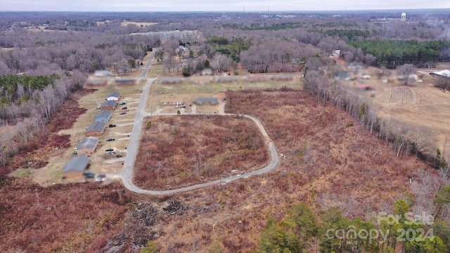 aerial view with a rural view and a wooded view