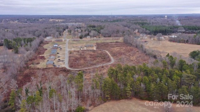 birds eye view of property with a rural view and a view of trees