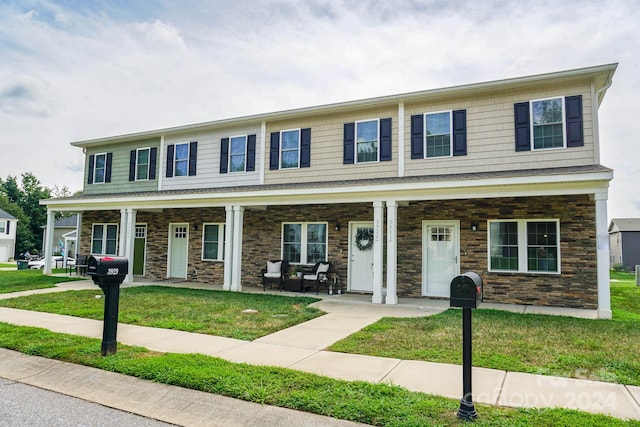 view of front of property featuring a porch and a front yard