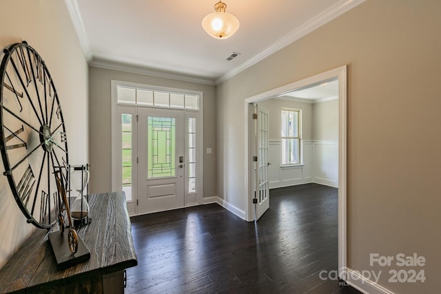 entrance foyer with ornamental molding, a healthy amount of sunlight, and dark wood-type flooring