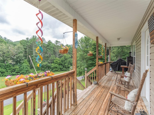 wooden terrace featuring grilling area