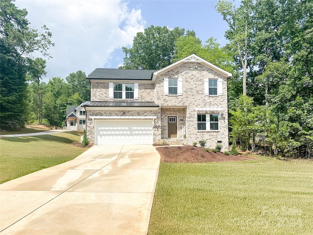 view of front of property featuring a garage and a front lawn