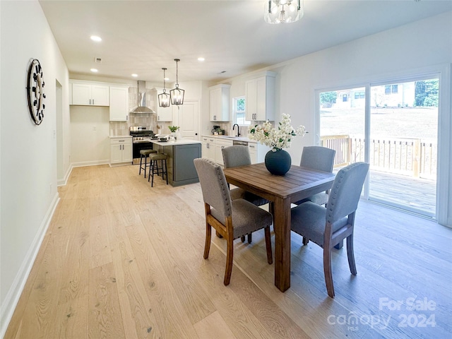 dining room with sink and light wood-type flooring