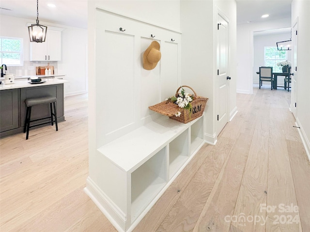 mudroom with light hardwood / wood-style floors