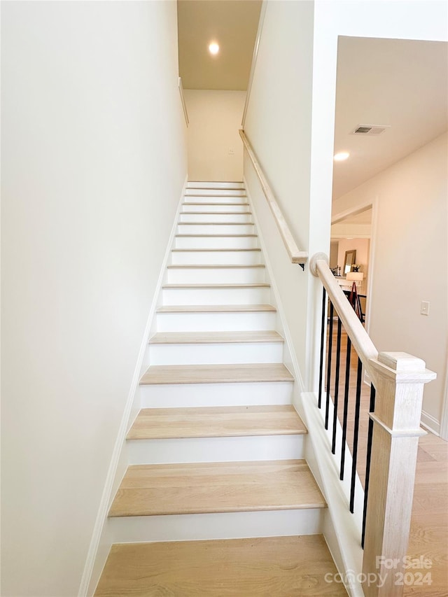 stairs with hardwood / wood-style floors