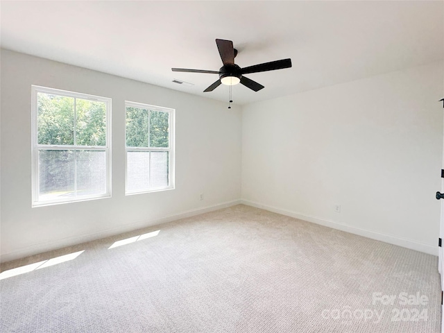 empty room with ceiling fan and carpet flooring