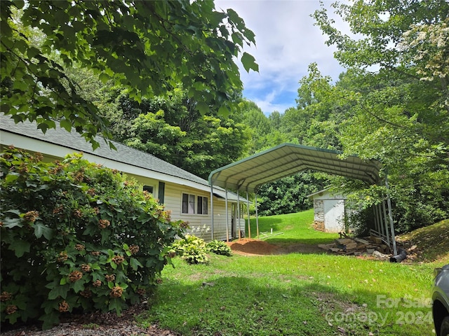 view of yard with a carport and a storage shed