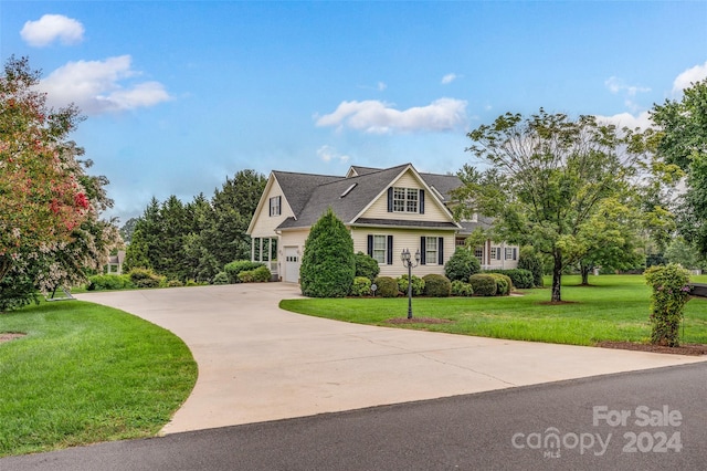 view of front of house with a garage and a front lawn