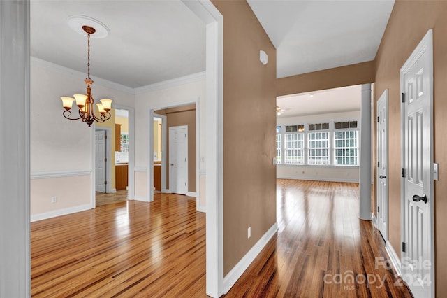 hall featuring an inviting chandelier and wood-type flooring