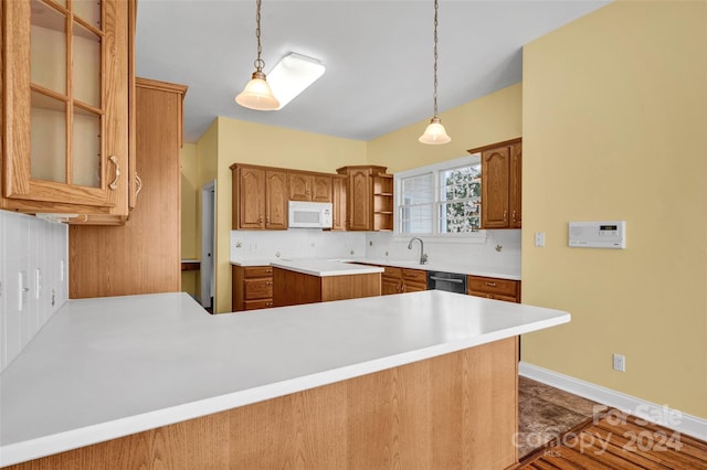 kitchen featuring tile patterned flooring, pendant lighting, kitchen peninsula, and backsplash