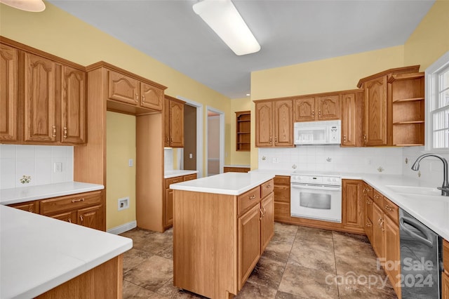 kitchen with white appliances, light tile patterned floors, backsplash, a center island, and sink