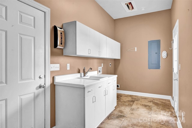 laundry area featuring hookup for a washing machine, cabinets, sink, electric panel, and light tile patterned flooring