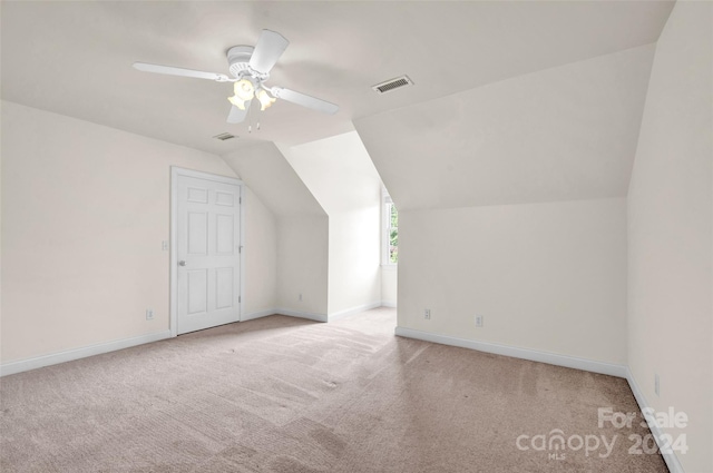 additional living space featuring ceiling fan, light carpet, and vaulted ceiling