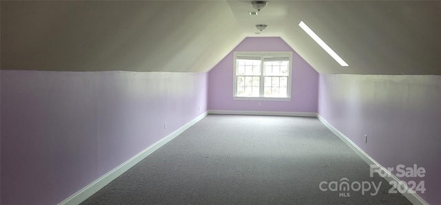 bonus room featuring vaulted ceiling and carpet floors