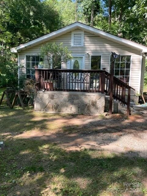 back of property with a wooden deck