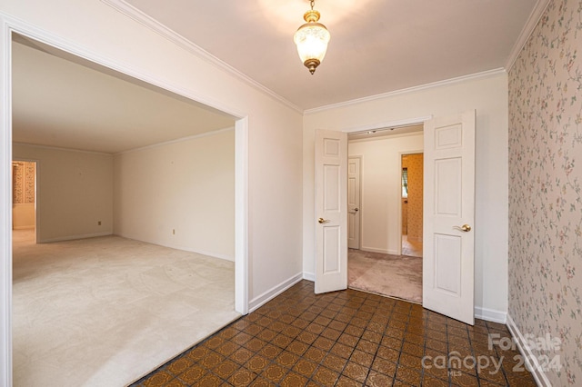 carpeted empty room featuring crown molding