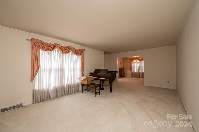 living area with ornamental molding, carpet flooring, and a chandelier