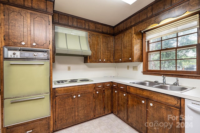 kitchen featuring white appliances, sink, extractor fan, and dark brown cabinets