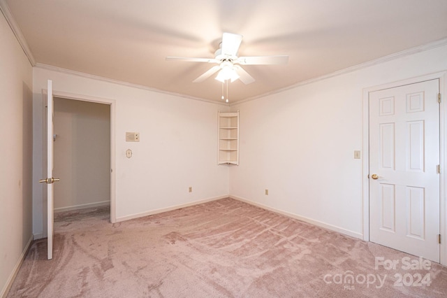 unfurnished bedroom with ornamental molding, light carpet, and ceiling fan