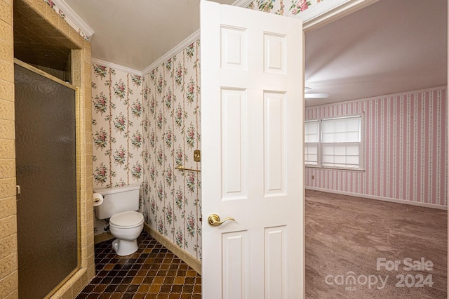 bathroom featuring crown molding, an enclosed shower, and toilet