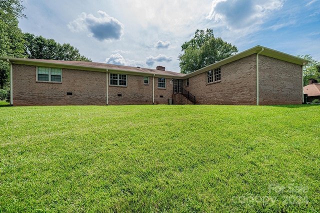 rear view of house with a yard