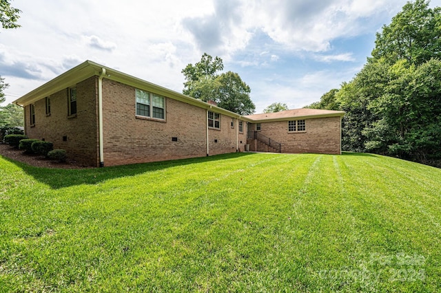 rear view of property featuring a yard