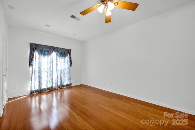 spare room featuring hardwood / wood-style floors and ceiling fan