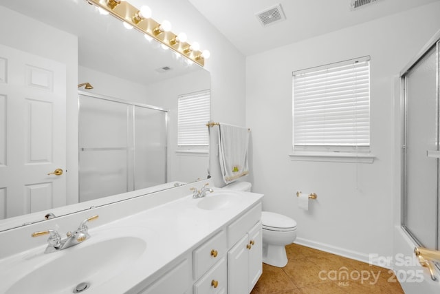 full bathroom with vanity, combined bath / shower with glass door, tile patterned floors, and toilet