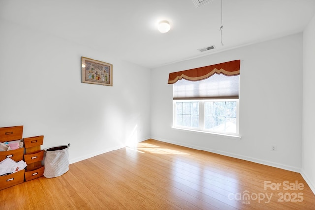 empty room with hardwood / wood-style floors