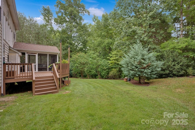 view of yard featuring a wooden deck and a sunroom