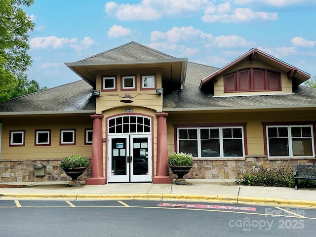 view of exterior entry featuring french doors