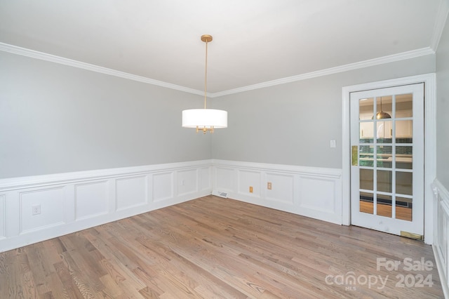 unfurnished dining area with light wood-type flooring and ornamental molding