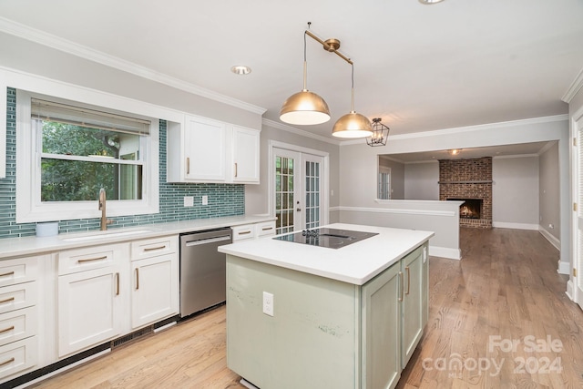 kitchen featuring a fireplace, stainless steel dishwasher, light hardwood / wood-style floors, sink, and a kitchen island