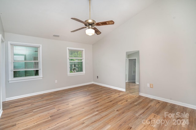 unfurnished room featuring ceiling fan, high vaulted ceiling, and light wood-type flooring