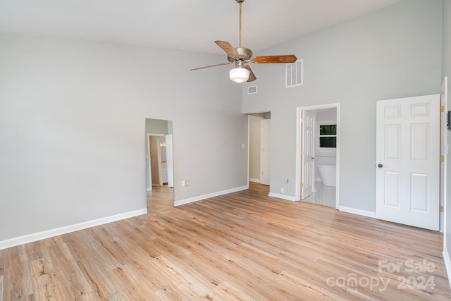 unfurnished bedroom with ceiling fan, high vaulted ceiling, light tile patterned floors, and connected bathroom