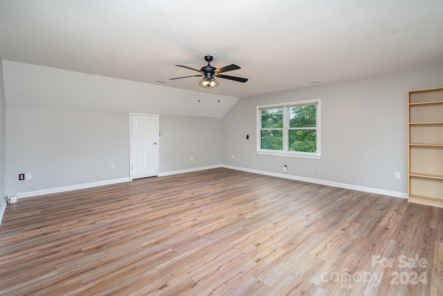 unfurnished living room with ceiling fan, vaulted ceiling, and light hardwood / wood-style floors