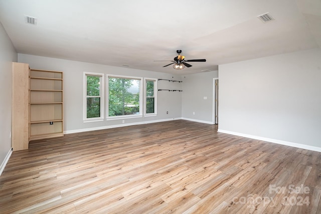 unfurnished living room featuring light hardwood / wood-style flooring and ceiling fan