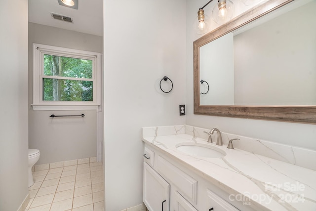 bathroom with tile patterned floors, vanity, and toilet