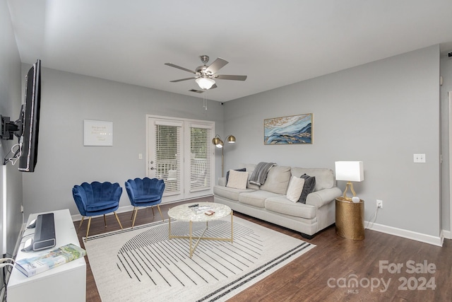 living area featuring dark wood-style flooring, visible vents, ceiling fan, and baseboards