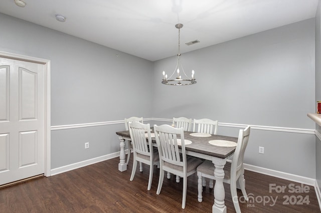dining space featuring a notable chandelier, baseboards, visible vents, and dark wood-style flooring