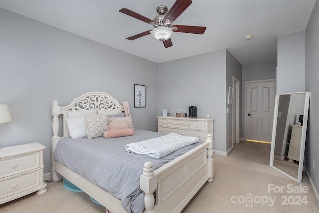 bedroom with light carpet, ceiling fan, and baseboards