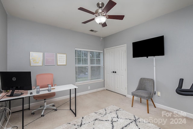 office featuring light carpet, baseboards, visible vents, and ceiling fan