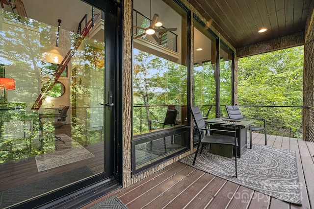 unfurnished sunroom featuring a wealth of natural light and ceiling fan