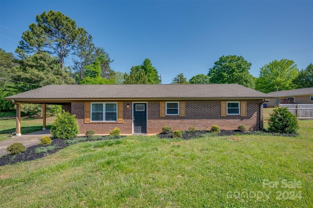 ranch-style home with a front yard and a carport